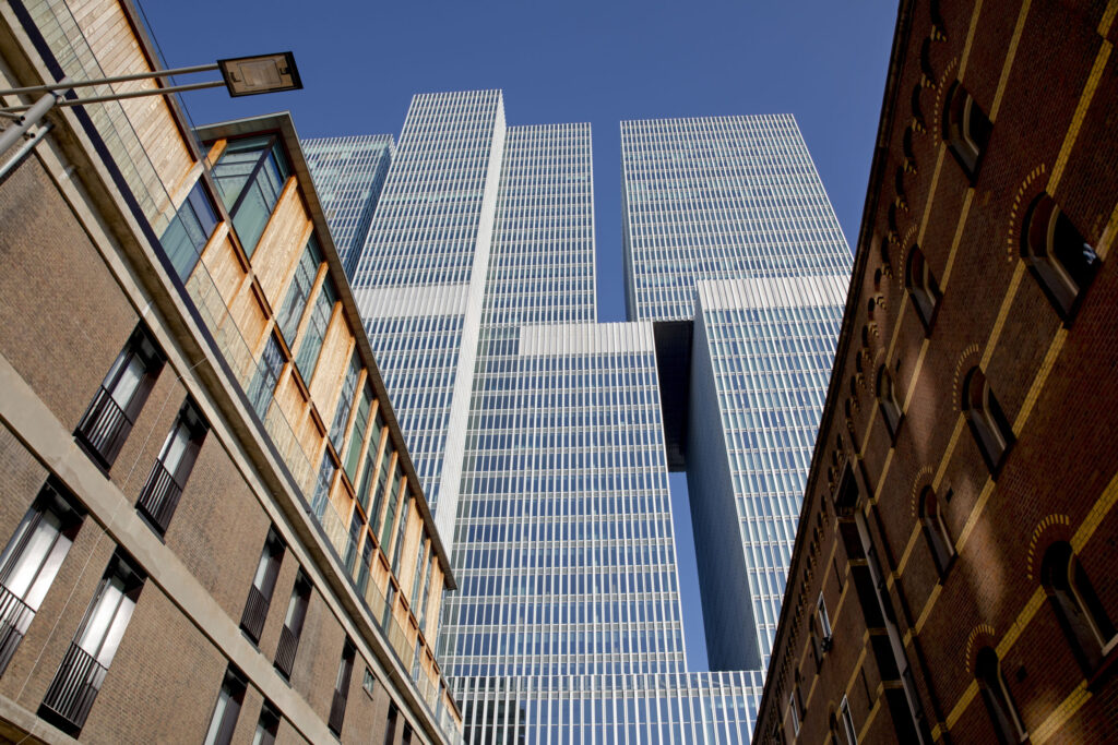 Architectuur detail: blik op De Rotterdam langs de verbouwde handelsveem pakhuizen op de Wilhelminapier.